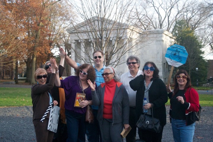 a group of people standing in front of a crowd posing for the camera