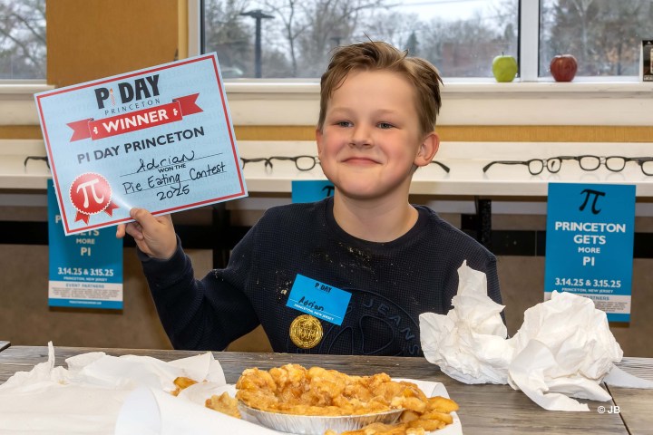 a woman sitting at a table with a plate of food