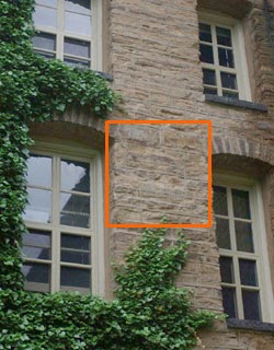 a sign in front of a brick building