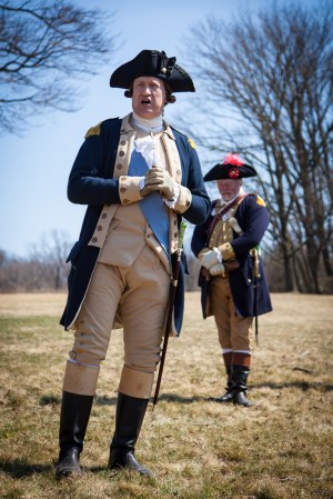 a group of baseball players standing on top of a grass covered field